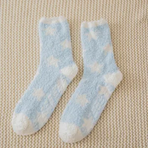 Cozy coral fleece winter sleep socks with anti-slip grip dots and cute star pattern details.