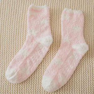 Pink and white star fuzzy coral fleece socks with anti-slip grips for cozy winter sleep.