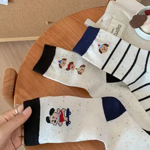 Cute patterned mid-calf socks for women featuring adorable dog and cartoon designs for autumn.
