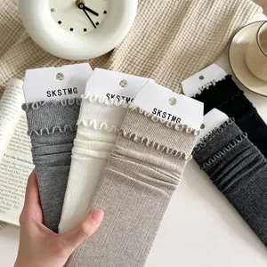 Women's ruffled mid-tube socks featuring a cozy knitted texture and elegant stacking design.