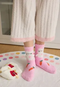 Cozy coral fleece fuzzy winter socks with cute cartoon rabbit and carrot patterns for women.