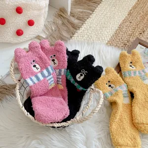 Close-up of thick coral fleece bear socks featuring cute 3D ears and scarf design detail.