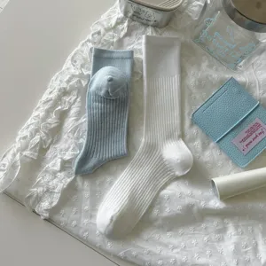 Ribbed mid-calf socks detail shot, breathable soft knit fabric in light blue and white colors.