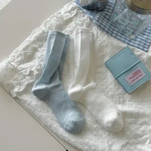 Detail shot of breathable women mid tube socks in light blue and white with ribbed knit design.
