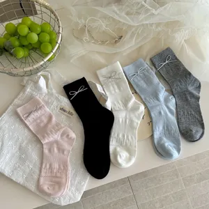 Chic bow decorative mid-calf socks featuring breathable mesh hollow design for spring and summer.