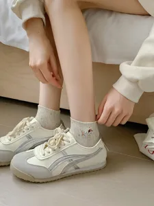 Cute embroidered short socks detail shot, soft cotton material, fresh Japanese style.