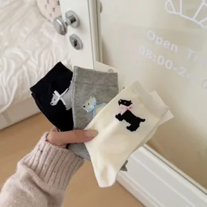 Detailed view of cute dog pattern mid-tube socks with soft fabric and sweet bow accent.
