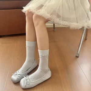 Women white floral mesh bow mid-calf socks paired with Mary Jane shoes, elegant detail shot.
