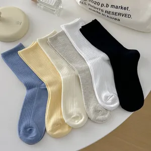 Close-up detail of multi-color ribbed mid-tube socks flat lay, soft texture, daily wear.