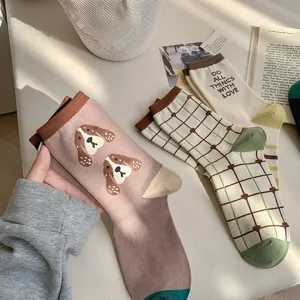Cute cartoon puppy and green plaid mid-calf socks detail shot, spring summer casual cute socks.