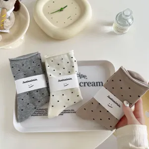 Japanese style polka dot rolled cuff mid-tube socks detail view, soft cotton knit fabric.