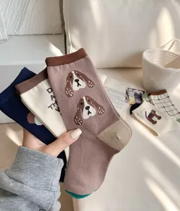 Close-up detail of cute cartoon dog pattern mid-tube cotton socks in various stylish colors.
