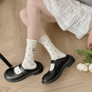 Detail view of women's summer mid-tube socks with cute heart jacquard and bow design.