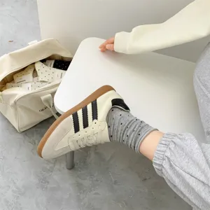 Detailed lifestyle shot showcasing grey polka dot crew socks paired with casual sneakers close up.