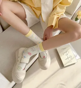 Close-up detail shot of cute cartoon printed mid-calf socks paired with platform shoes.