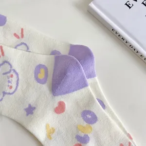 Cute cartoon puppy pattern mid-tube socks with purple heel, soft cotton knit detail.