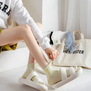 Detail view of women's short cotton socks featuring embroidered letter c and solid design.
