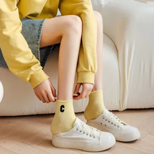 Close-up detail of women's short cotton socks with embroidered letter C, soft and comfy.