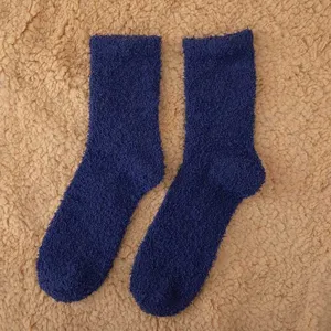Dark blue plush fuzzy socks for women and men, warm winter mid-tube fleece socks.