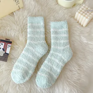 Cozy fuzzy striped coral fleece socks detail shot in soft green and white tones for winter warmth.
