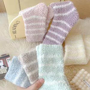 Cozy striped coral fleece socks detail shot, soft plush texture for warm winter sleep comfort.