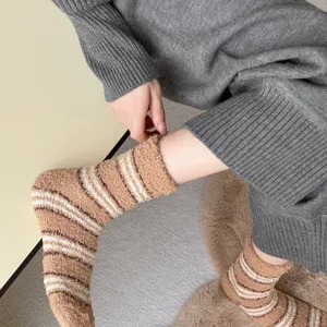 Detail view of fuzzy striped coral fleece sleep socks, thick and warm for home and indoor floor.