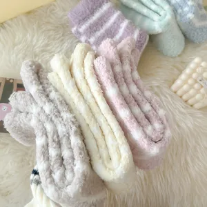 Close-up detail of thick striped coral fleece cozy sleep socks, ultra-soft texture.