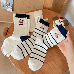 Cute puppy embroidery detail on white cotton mid-tube socks, cozy daily wear style.