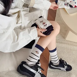 Cute dog embroidered cotton mid-calf socks for women, stylish stripe design, detail view.