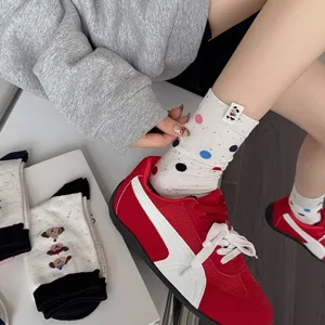 Korean style cute speckled cotton mid-tube women socks with adorable dog patterns and tags.