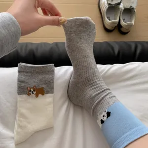 Close-up detail of cute cartoon puppy embroidered striped mid-calf socks for women and girls.