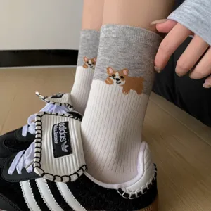 Close-up detail of cute corgi pattern mid-tube socks paired with casual sneakers.