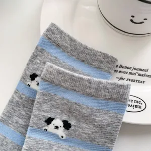 Detailed close-up of blue-grey striped women's mid-tube socks with cute cartoon puppy design.