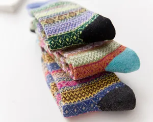 Close-up detail of colorful vintage ethnic wool socks stacked neatly, soft knit texture.