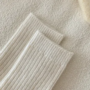 Detailed shot of thick wool blend ribbed sock cuff, showing cozy winter texture and warmth.