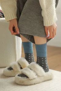Cozy women's mid-tube wool socks with polka dots and soft fuzzy house slippers for winter.