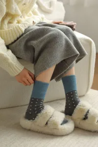 Cozy wool mid-calf socks with cute polka dot pattern and stylish blue grey color block detail.