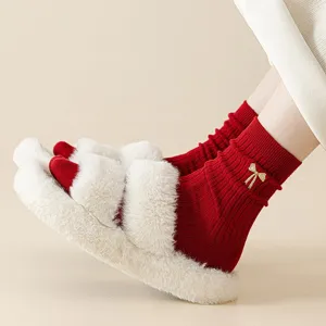 Red cotton socks for women with gold bow embroidery, paired with warm fluffy winter slippers.