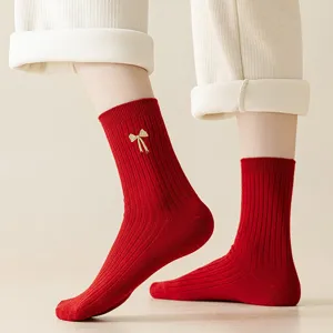 Women red ribbed cotton socks with cute gold bow embroidery, comfortable mid-calf winter hosiery.
