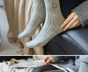 Cozy grey ribbed knit winter socks featuring cute smiley face embroidery warm casual apparel.