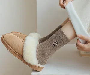 Close-up of cozy winter fleece slippers and embroidered knit socks in a clean indoor setup.