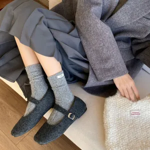 Textured cable knit wool slouch socks detail shot, cozy winter style, soft warm aesthetic
