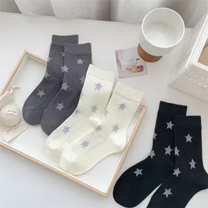 Detailed view of stylish women's mid-tube socks featuring star patterns and cozy ribbed cuffs.