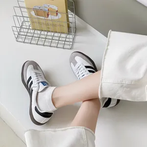 Detail shot of women white socks paired with retro casual sneakers in minimalist style.