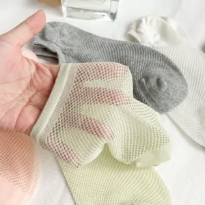 Close-up of breathable mesh ankle socks in assorted candy colors showing fine knit detail.