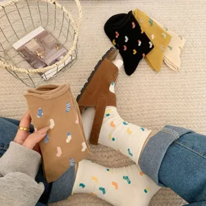 Detail view of Japanese style cute polka dot mid-tube socks paired with casual brown sandals on soft carpet.