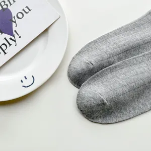 Close-up detail of soft grey knit women low cut socks, flat lay product photography.