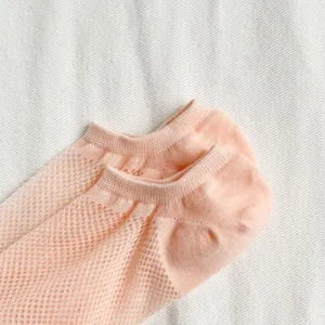 Close-up detail of pink mesh ankle socks, breathable candy color summer casual footwear.