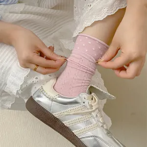 Cute pink polka dot mid-tube socks for women, featuring sweet rolled lettuce edge design.