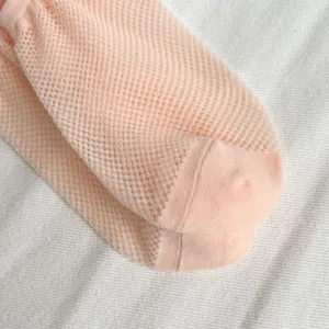 Close-up detail of women spring summer breathable pink mesh short socks, soft comfy casual.